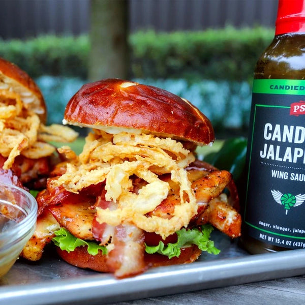 Candied Jalapeno Chicken Sandwich next to a bottle of Candied Jalapeno.